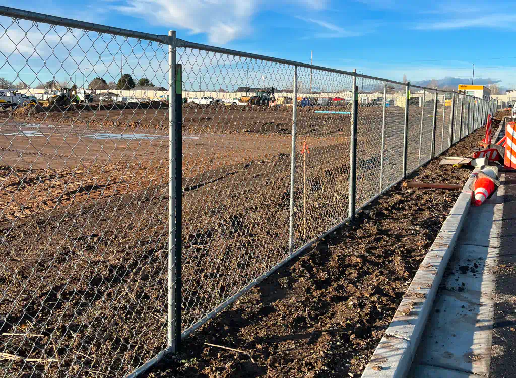 chain link fence installed in an empty construction site